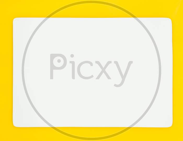 A Rectangle Empty White Plate Isolated On The Yellow Background.