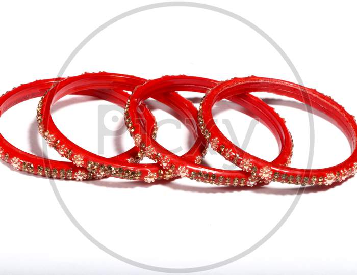 Closeup Of Red Bracelets Decorated With Small Stones Isolated On A White Background