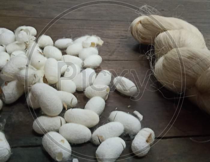silk cocoons on a wooden board
