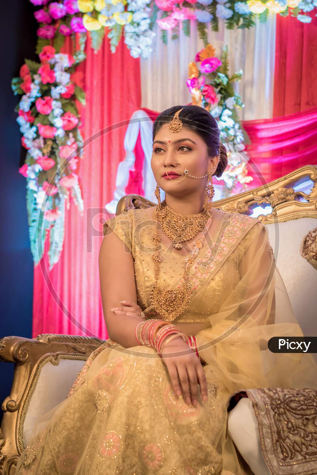 August 2019, Kolkata, India: Portrait Of An Indian Bride Standing With Glamorous Outfit And Jewellery With Makeup In A Banquet Hall. Traditional Indian Bride In Wedding