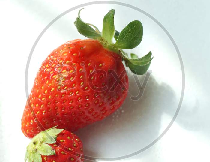 Two Strawberries Close Up On White Background