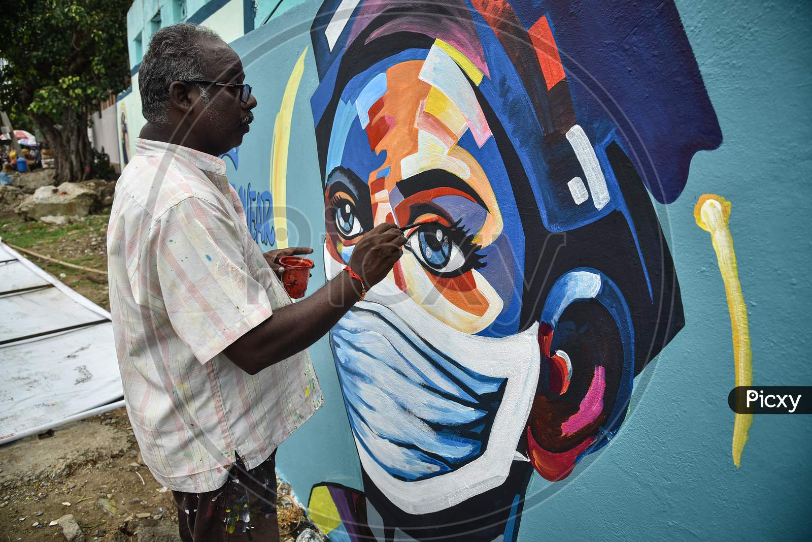 An Artist Paints A Mural On A Wall To Create Awareness On Wearing A Face Mask To Prevent The Spread Of Coronavirus, In Vijayawada, August 05, 2020.