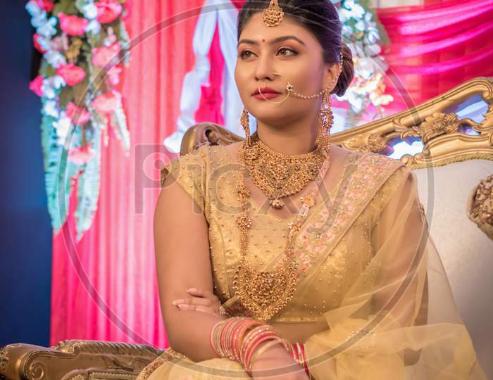 August 2019, Kolkata, India: Portrait Of An Indian Bride Standing With Glamorous Outfit And Jewellery With Makeup In A Banquet Hall. Traditional Indian Bride In Wedding