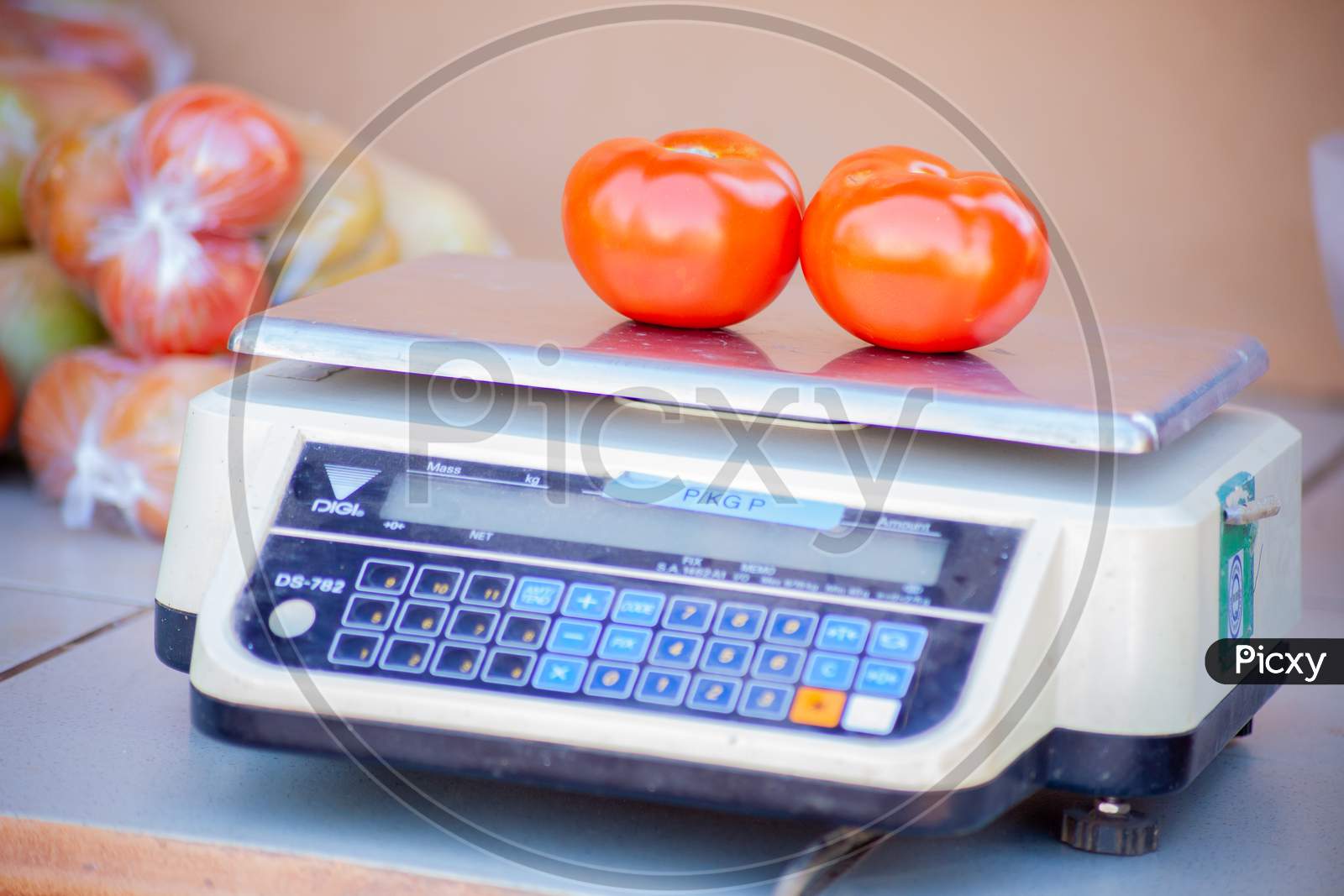A Red Ripe Tomatoes On A Weighing Machine.Macro