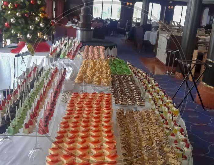 Assorted French Pastries ,A Large Log And Chocolate Fountain ,A View From Cruise Ship Buffet During X 'Mas Time