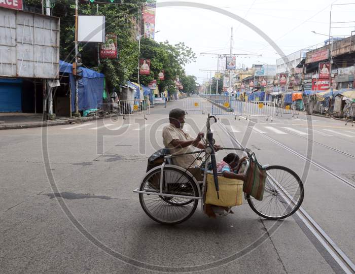 A differently abled man crosses a street that wears a deserted look amid the complete bi-weekly lockdown imposed by the government to curb Coronavirus spread in Kolkata on August 8, 2020