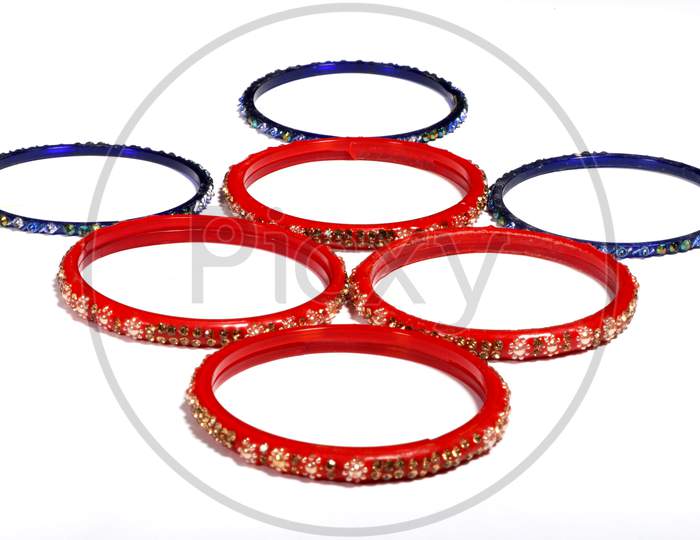 Red And Blue Bracelets Decorated With Colorful Small Stones Isolated On A White Background