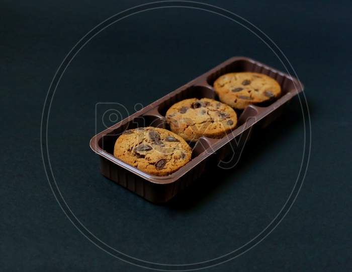 Chocolate Chip Cookies Isolated On Black Background. Chocolate cookies on black background. Chocolate chip cookie on black background with copy space for text, closeup.