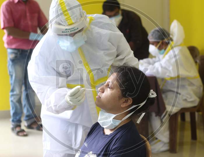 A healthcare worker collects samples from a person for Covid -19 antigen testing amid the complete bi-weekly lockdown to curb Coronavirus spread in Kolkata on August 8, 2020
