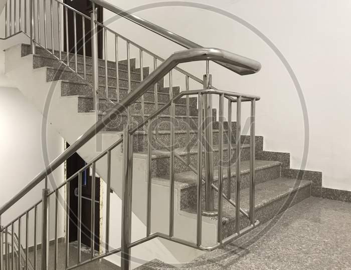 Fire Emergency Staircase Images Having Two Hour Fire Rated Wooden Door And Granite Finished Steps And Safety Handrails Made Of Stainless Steel Pipes During Emergency To Reach Assembly Point