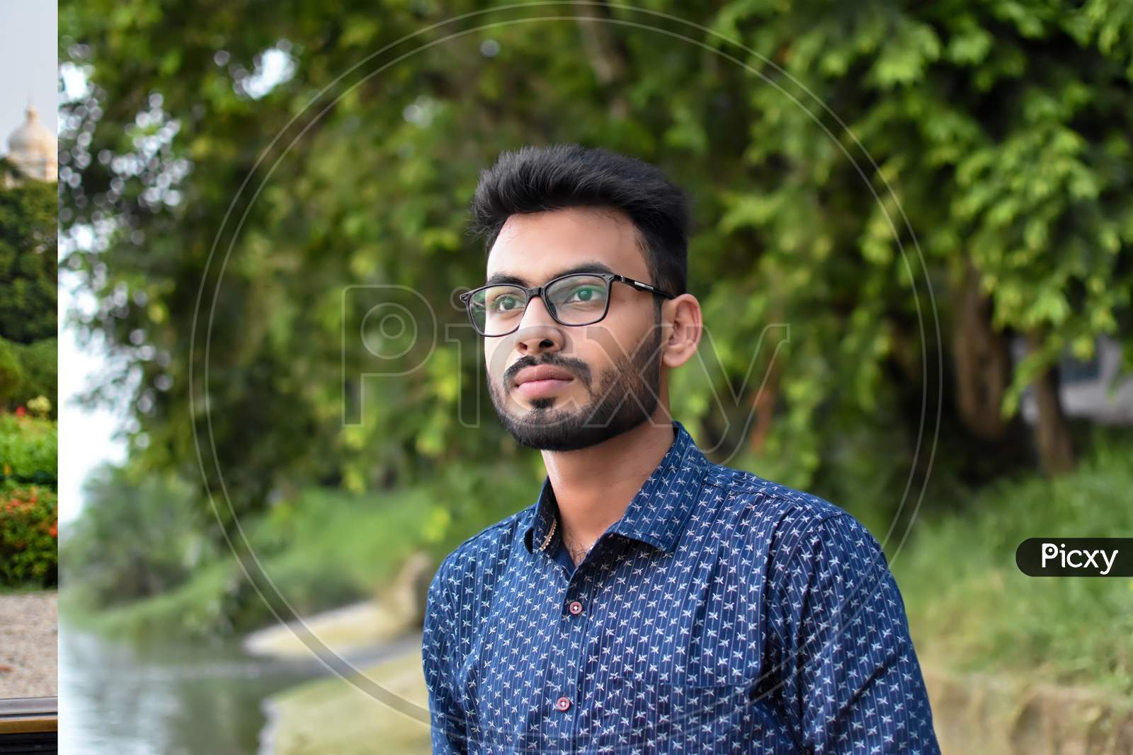 Portrait Of A Young And Handsome Indian Bengali Man Standing In Front Of A Vintage House Wearing Green Indian Traditional Punjabi. Indian Lifestyle And Fashion.