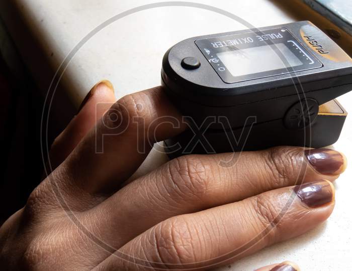 Measuring Of Pulse And Oxygen Level With Oximeter Machine.