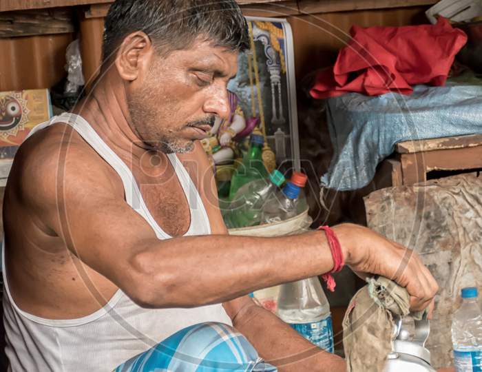 Indian Roadside Tea Vendor Is Pouring Tea On A Soil Pot From His Kettle. Indian Lifestyle In North Kolkata, India On August 2019