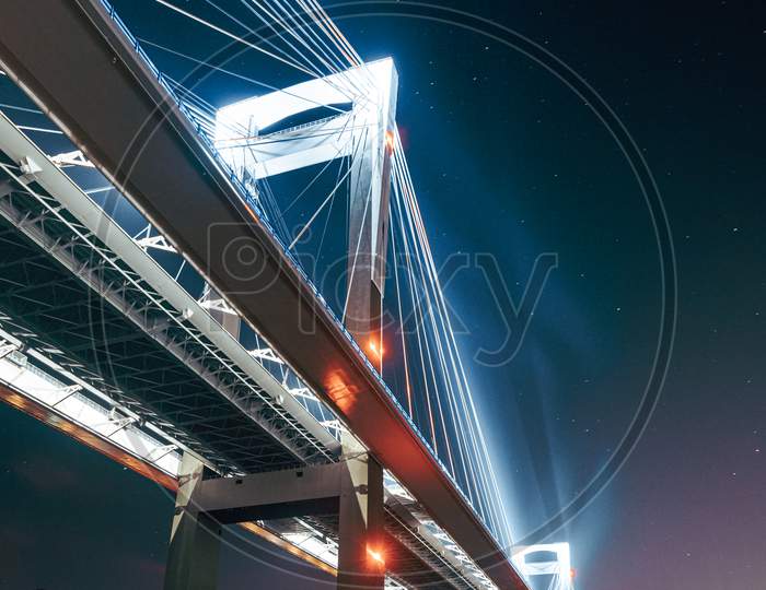 A Luminous Bridge From Below Reflecting In The Water