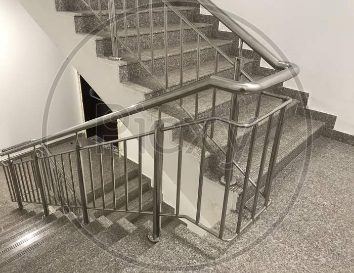 Fire Emergency Staircase Images Having Two Hour Fire Rated Wooden Door And Granite Finished Steps And Safety Handrails Made Of Stainless Steel Pipes During Emergency To Reach Assembly Point