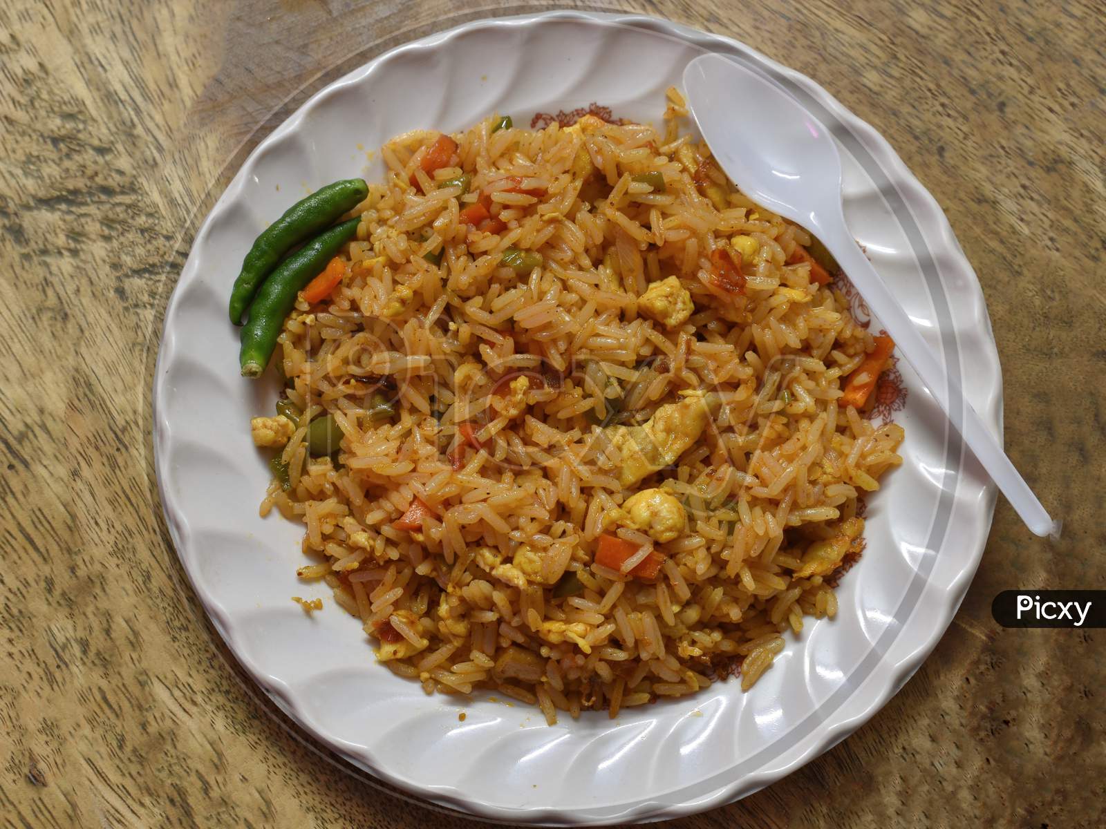 Fried Rice Is A Dish Of Cooked Rice That Has Been Stir-Fried In A Wok Or A Frying Pan And Is Usually Mixed With Other Ingredients Such As Eggs, Vegetables, Seafood, Or Meat.