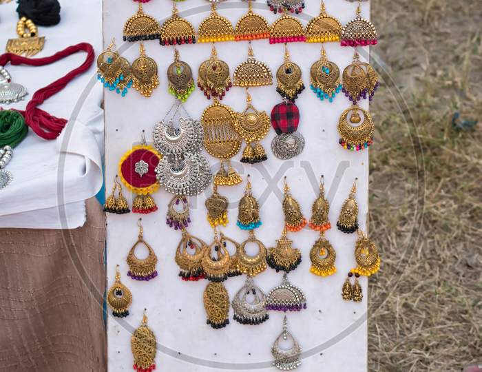 Indian Traditional Handmade Earrings With Blurred Background Is Displayed In A Street Shop For Sale. Indian Handicraft And Art
