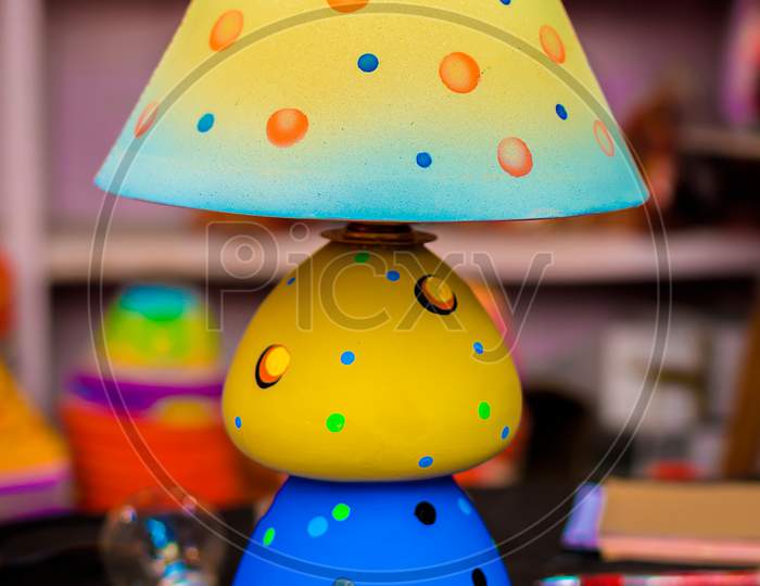 An Illuminated Decorative Handmade Table Lamp Is Displayed In A Street Shop For Sale. Indian Handicraft And Art