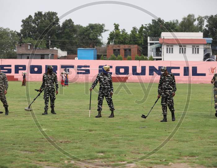 CRPF, BSF personnel frisk the mini stadium ground ahead of Independence Day parade in Jammu on August 9, 2020.