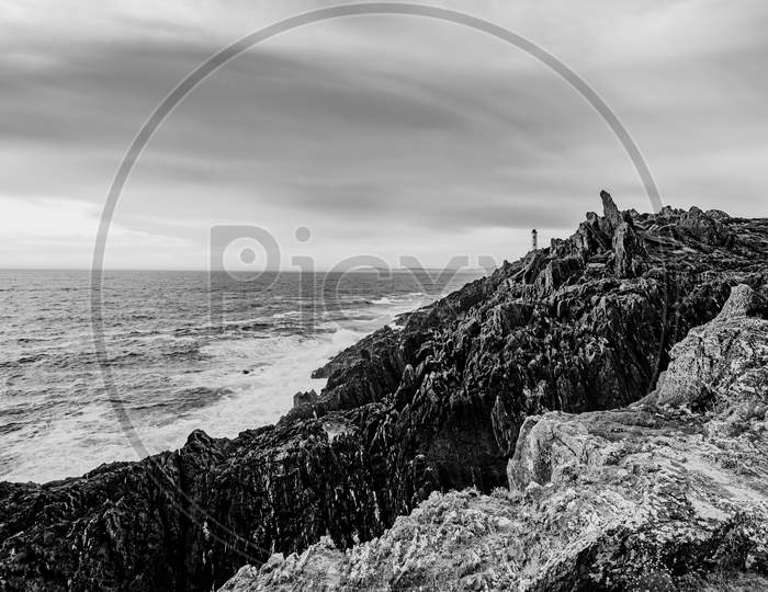 Black And White Dramatic Shot Of The Lighthouse On The Broken Coast Of Galicia