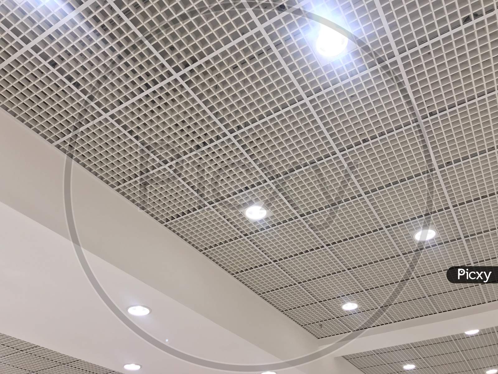 An White Painted Emulsion Painted For An Gypsum Ceiling With Macro Grid Ceiling For An Suspended False Ceiling Of An Shopping Mall Interiors Architecture Work In Muscat Oman