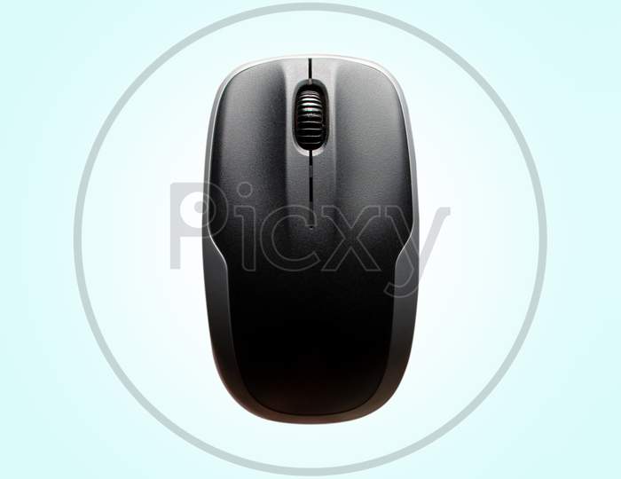 Above View Of Computer Mouse On Light Blue Background. Above View Of Computer Mouse On Light Blue Background. Black And Grey Computer Mouse.