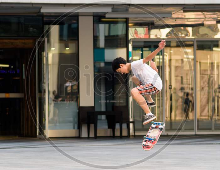 Skater With A Skateboard In Modern Sanlitun Area Of Beijing, China
