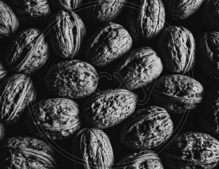 A Black And White Shot Of Some Nuts From Above