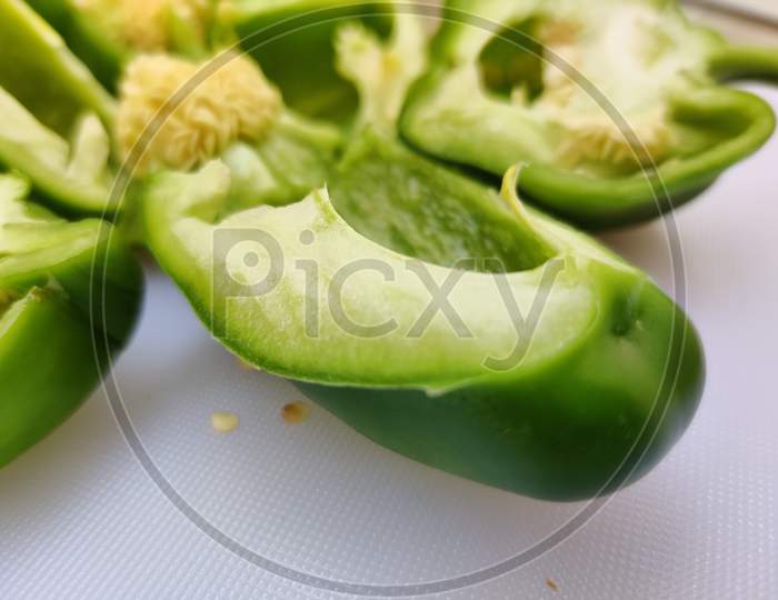 slice of green bell pepper or capsicum isolated on white background
