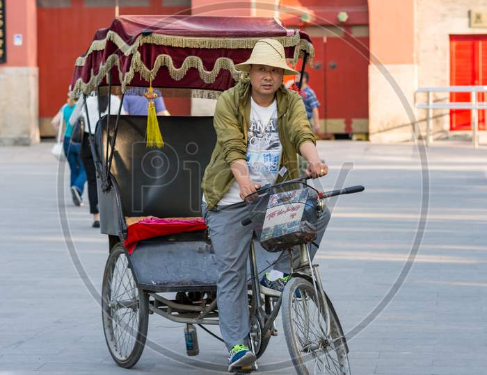 Bicycle Rickshaw Driver Waiting For Customers In Beijing, China