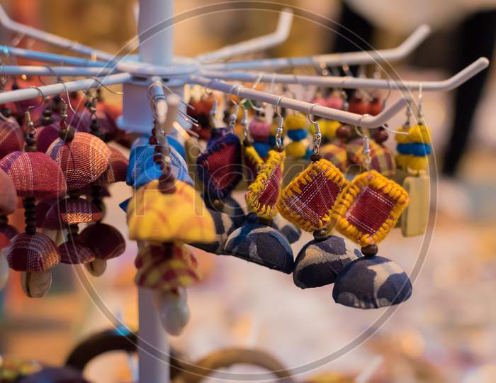 Indian Traditional Handmade Earrings With Blurred Background Is Displayed In A Street Shop For Sale. Indian Handicraft And Art