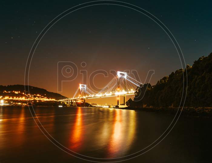 Bridge During Night Reflecting Into The Sea