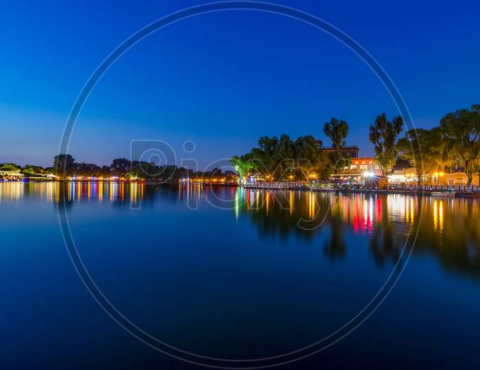 Peaceful Reflection Of The Evening Blue Hour In Shichahai Lake In Beijing