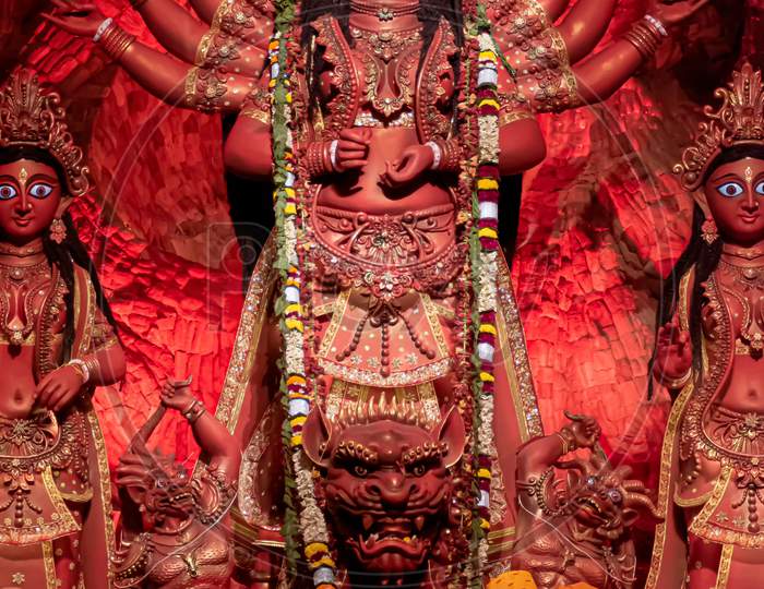 Goddess Durga Idol At Decorated Durga Puja Pandal, Shot At Colored Light, In Kolkata, West Bengal, India. Durga Puja Is Biggest Religious Festival Of Hinduism And Is Now Celebrated Worldwide.
