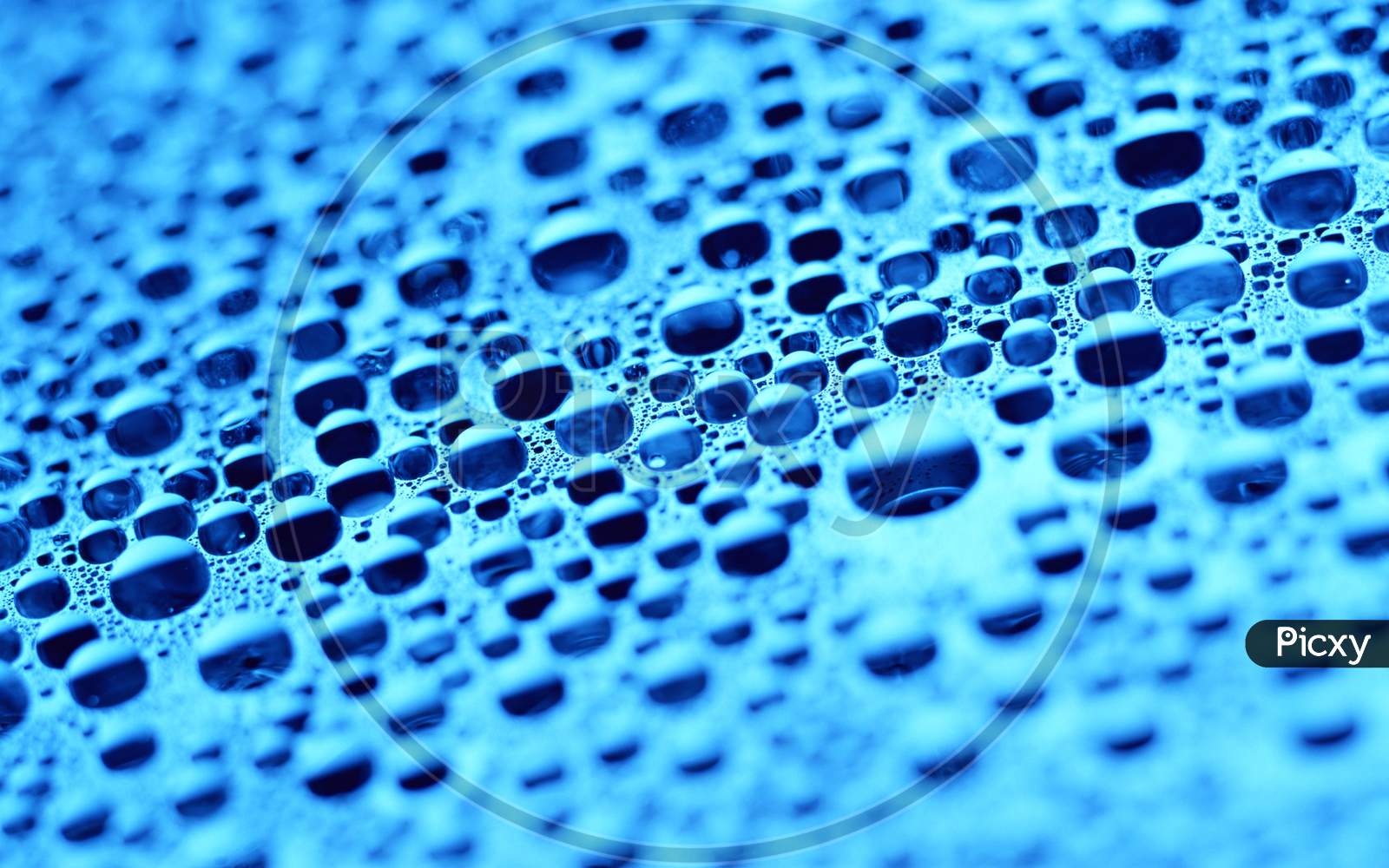 Close-up of water drops on blue colour background
