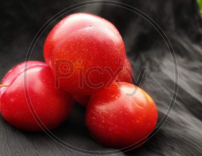 Red plum on black background