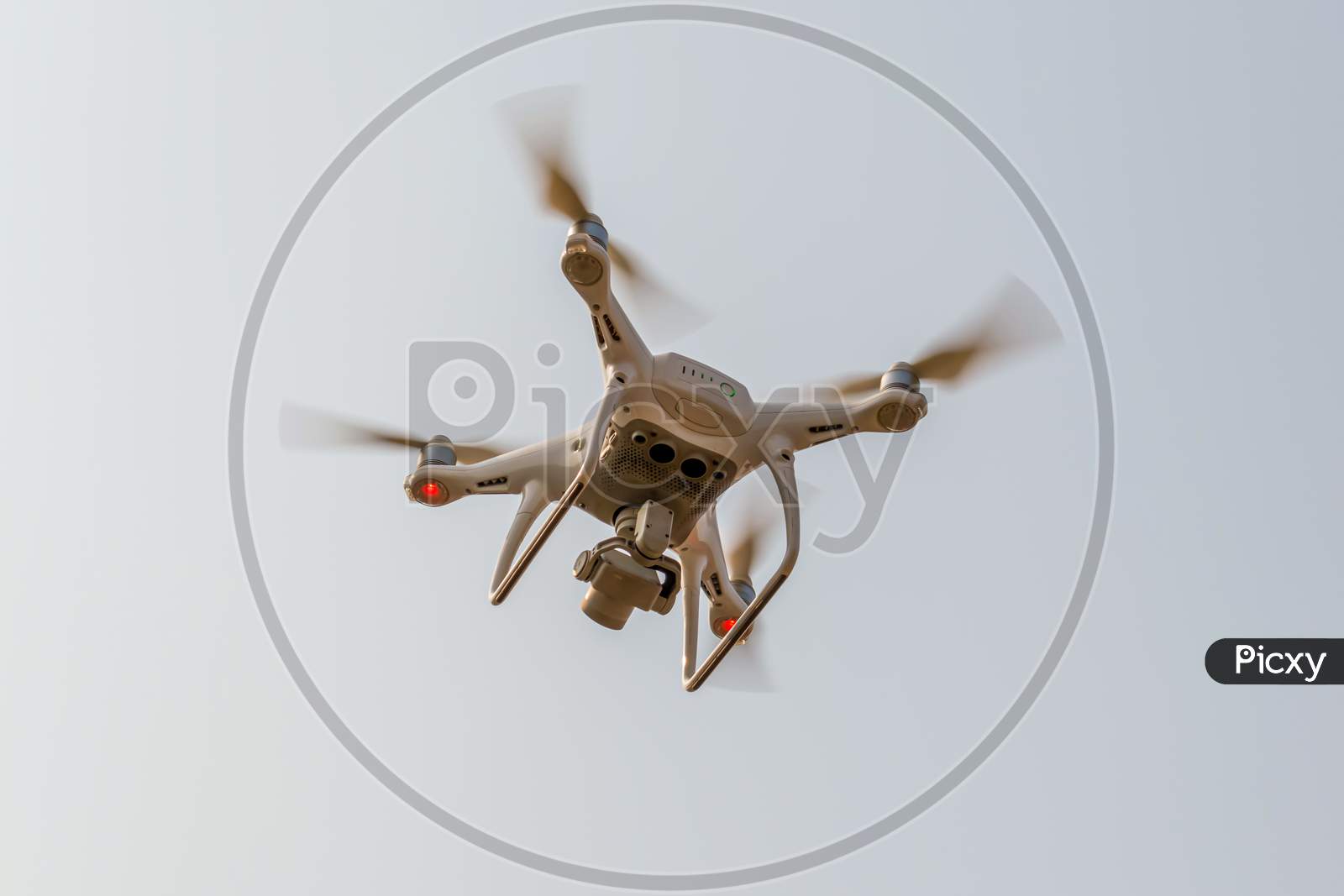 Modern Rc Drone / Quadcopter With Camera Flying In A Bright And Clear Blue Sky. New Technology In The Aero Photo Shooting.