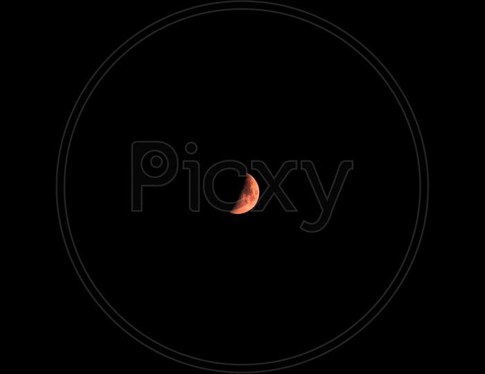 A Red Moon Over A Full Black Background