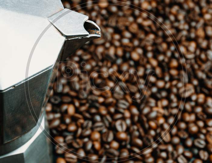 A Close Up Of A Pot Surrounded By Coffee Grains