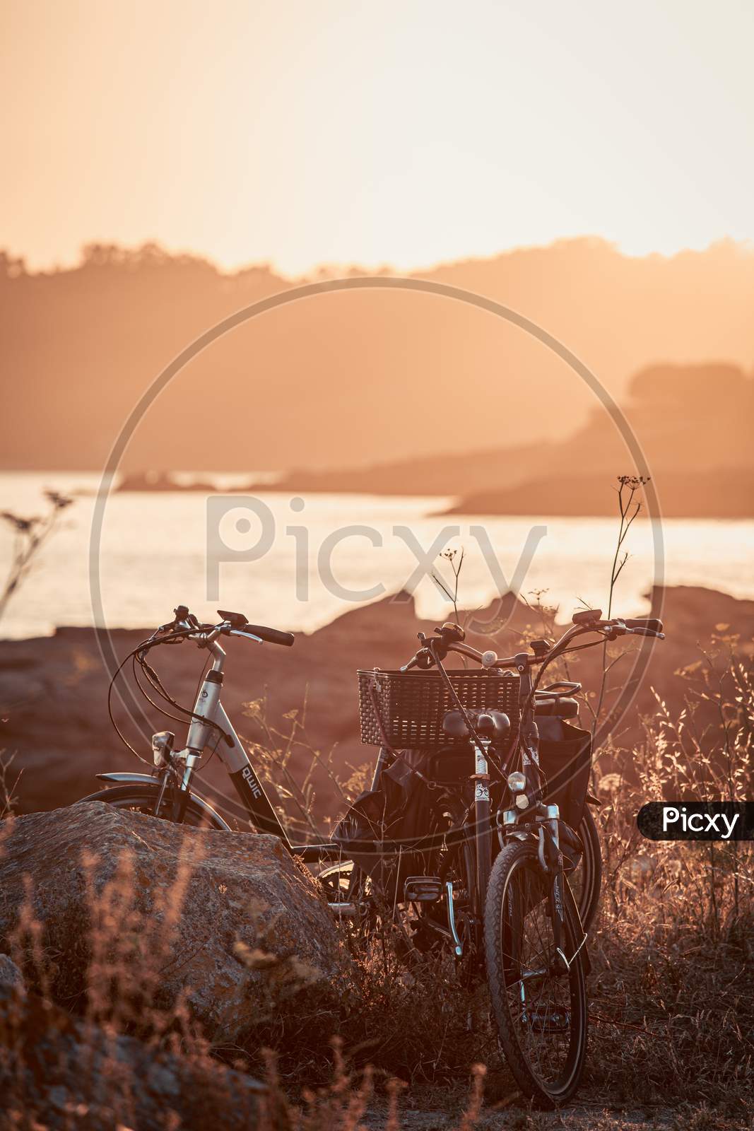 Two Vintage Bikes On The Beach During The Sunset