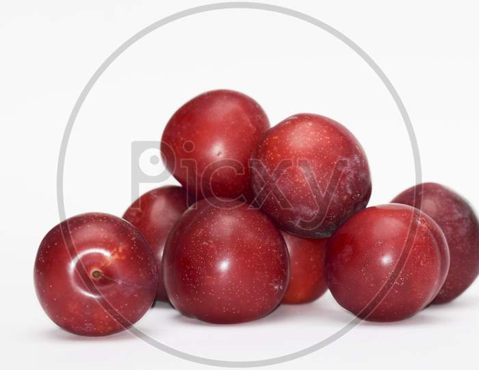 Fresh Fruits From India Red Plums Known As Alubukhara Or Aloobukhara In Indian Subcontinent. Heap Of Fruits On White Background. Cherry Plum