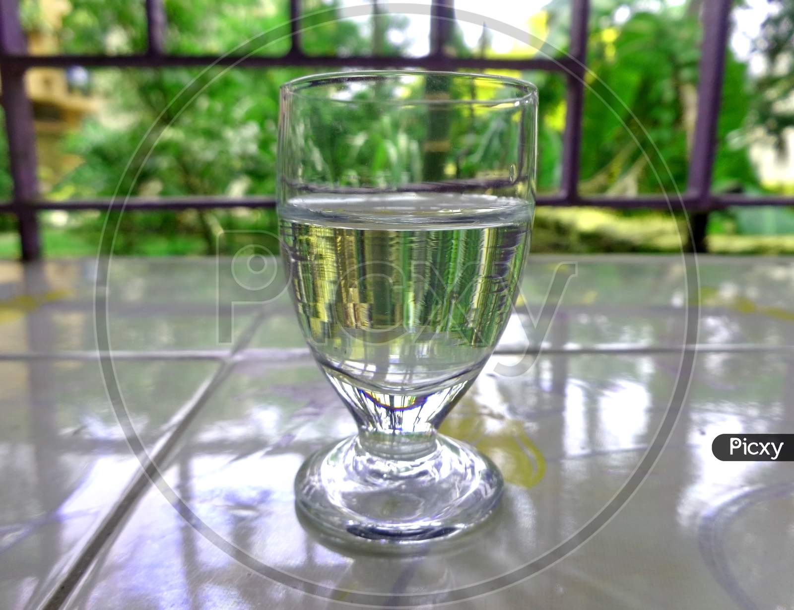 A Glass Fill With Half Of Water