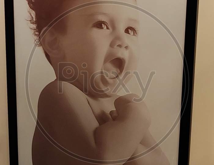 Baby photo frame on a wall
