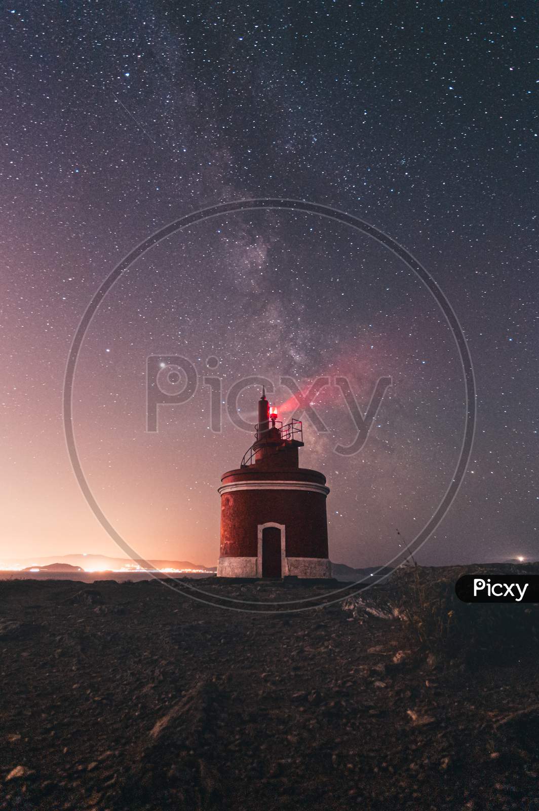 Lighthouse During The Night With The Milky Way Behind