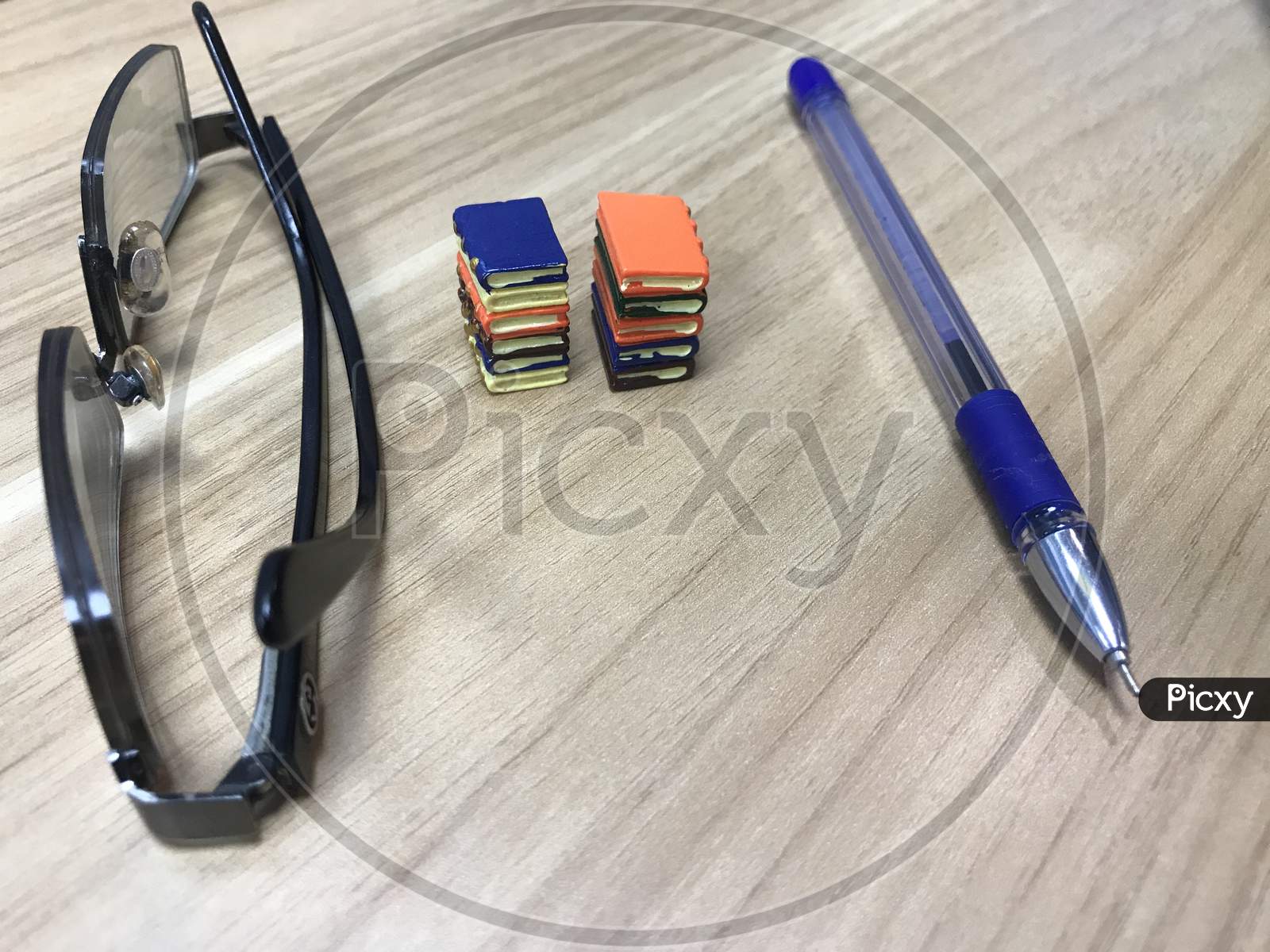 Book Toys And A Pen Representing A Life Of An Writer Who Can Impose His Ideas To People Who Like To Improve Their Literacy Level