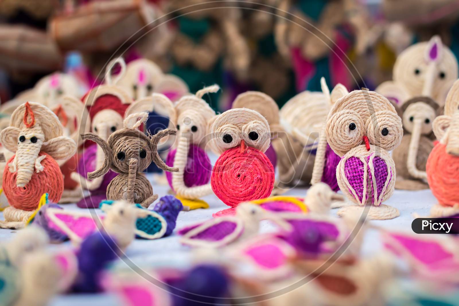 Indian Traditional Handmade Puppet Dolls Made Of Jute Isolated On Blurred Background Is Displayed In A Street Shop For Sale. Indian Handicraft And Art