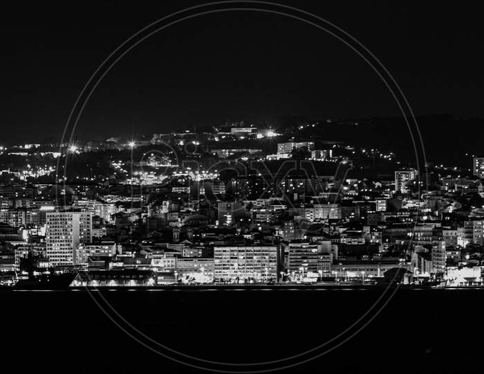 A Black And White City Landscaped During The Night