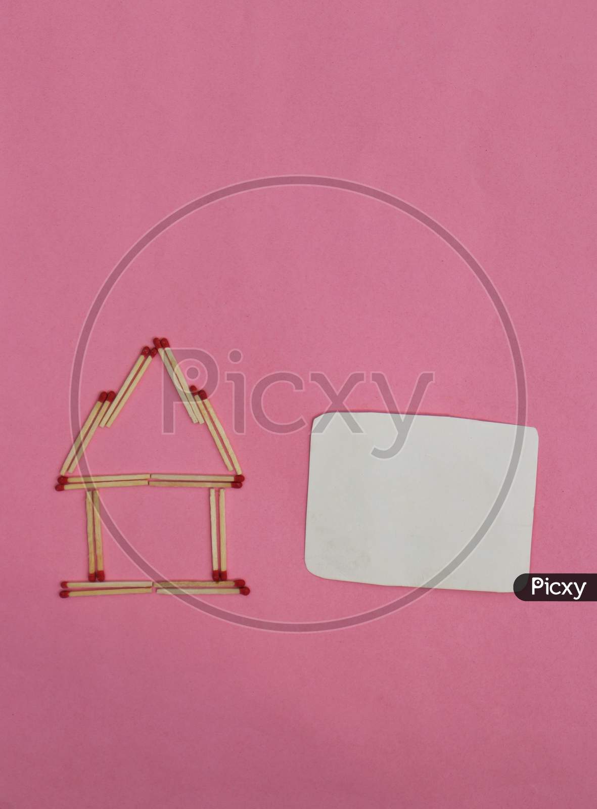 Stay At Home Conceptual Photo With Match Stick Made House With Blank Copy Space For Texts Writing Isolated On Pink Background
