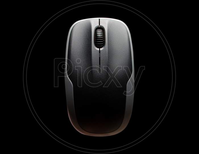 Above View Of Computer Mouse On Black Background. Black And Grey Computer Mouse. Computer Mouse Isolated On The Black Background.