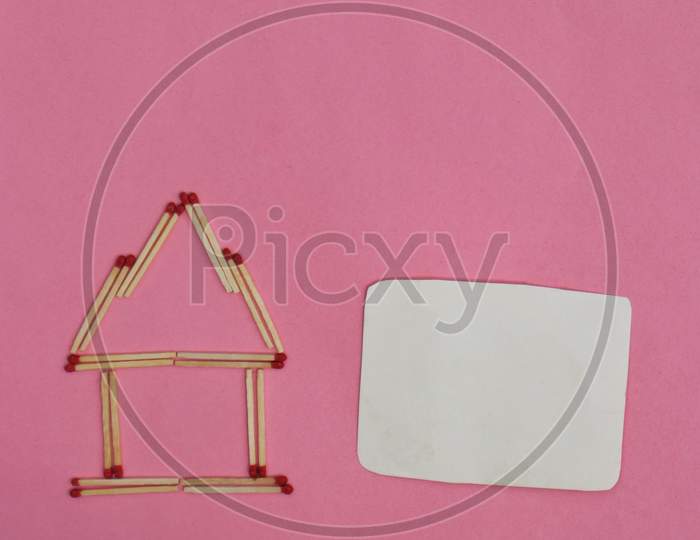 Stay At Home Conceptual Photo With Match Stick Made House With Blank Copy Space For Texts Writing Isolated On Pink Background